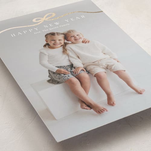 This is a snow foil pressed holiday cards with foil pressed by Kaydi Bishop called bow tied printing on recycled smooth signature in standard