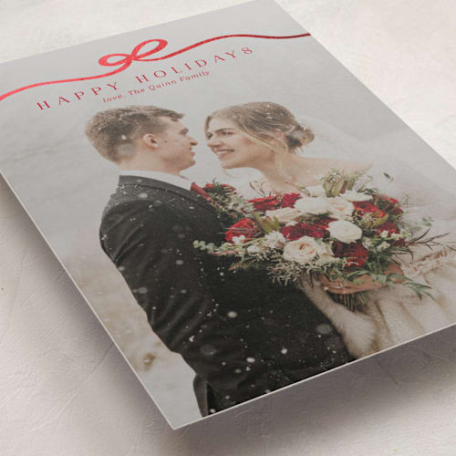 This is a cardinal foil pressed holiday cards with foil pressed by Kaydi Bishop called bow tied printing on recycled smooth signature in standard