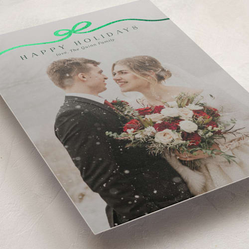 This is a pine foil pressed holiday cards with foil pressed by Kaydi Bishop called bow tied printing on recycled smooth signature in standard