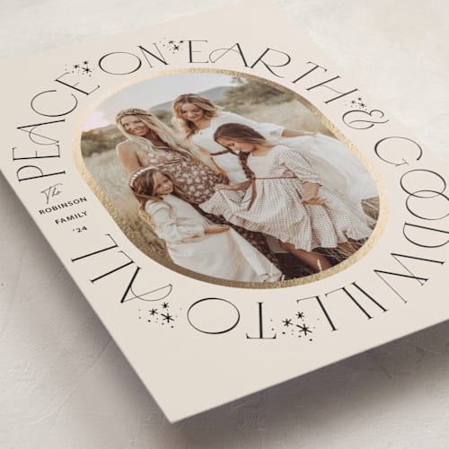 This is a ivory foil pressed holiday cards with foil pressed by Hannah Williams called peace on earth oval printing on recycled smooth signature in standard
