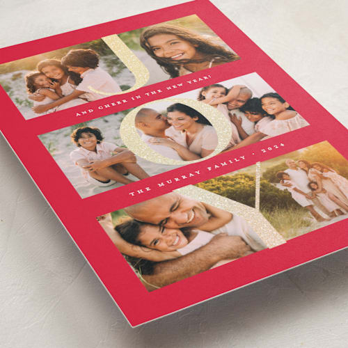This is a ruby foil pressed holiday cards with foil pressed by Lauren Chism called joy in photos printing on recycled smooth signature in standard