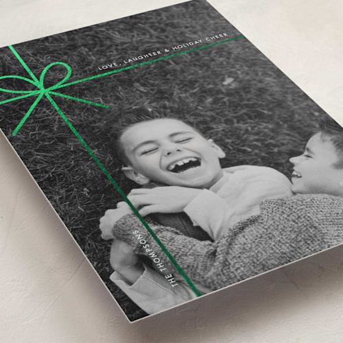 This is a mint foil pressed holiday cards with foil pressed by Joyce Pinheiro called tied in cheer printing on recycled smooth signature in standard