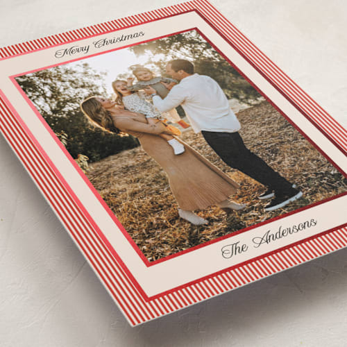 This is a ruby foil pressed holiday cards with foil pressed by Annie Shapiro called little stripes printing on recycled smooth signature in standard