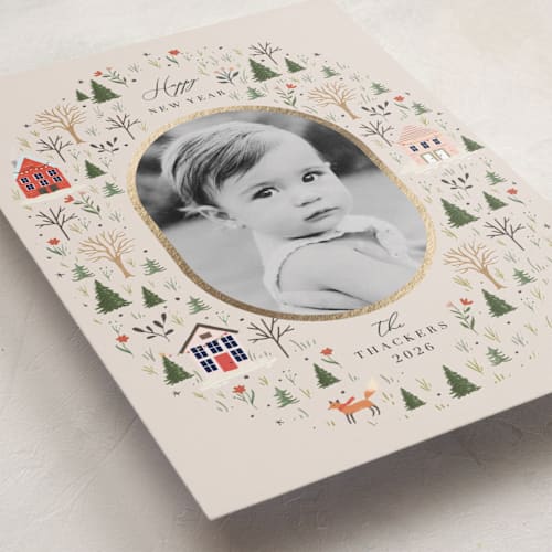 This is a taffy foil pressed holiday cards with foil pressed by Hannah Williams called winter village oval printing on recycled smooth signature in standard