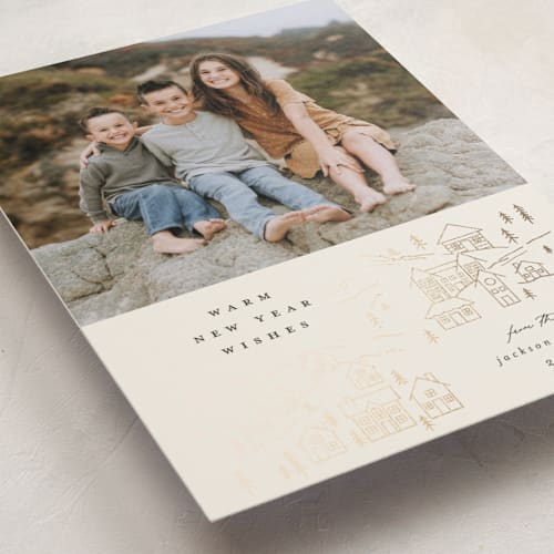 This is a latte foil pressed holiday cards with foil pressed by Carolyn Nicks called wintry town printing on recycled smooth signature in standard