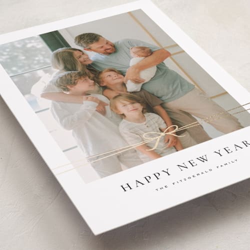 This is a coal foil pressed holiday cards with foil pressed by Wildfield Paper Co called delicate ribbon printing on recycled smooth signature in standard