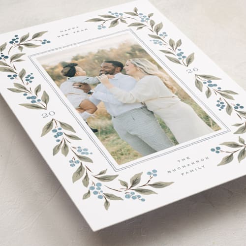 This is a juniper berry foil pressed holiday cards with foil pressed by Wildfield Paper Co called poinsettia + pine printing on recycled smooth signature in standard