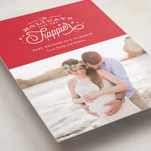 This is a poinsettia pregnancy announcements with standard by Jennifer Wick called happier holidays printing on smooth signature in standard