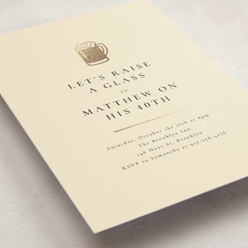 This is a creme holiday party invitations with foil pressed by mo kelley called raise a glass printing on signature in standard