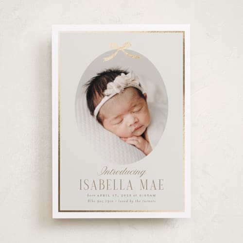 This is a cashmere foil stamped birth announcements with foil pressed by Erin German called tied with a bow printing on recycled smooth signature in standard