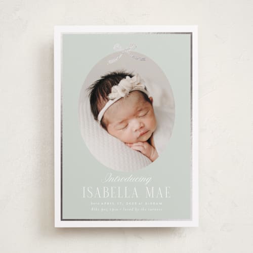 This is a aloe foil stamped birth announcements with foil pressed by Erin German called tied with a bow printing on recycled smooth signature in standard