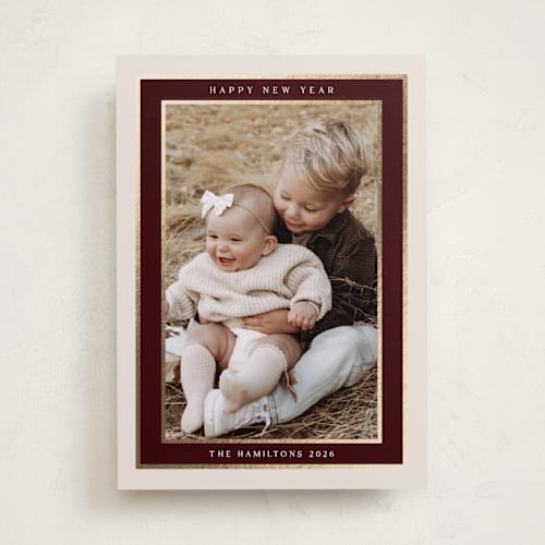 This is a maroon foil pressed holiday cards with foil pressed by Nicole Walsh called encompass printing on recycled smooth signature in standard