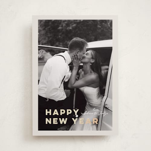 This is a ivory foil pressed holiday cards with foil pressed by Benita Crandall called glittering love printing on recycled smooth signature in standard