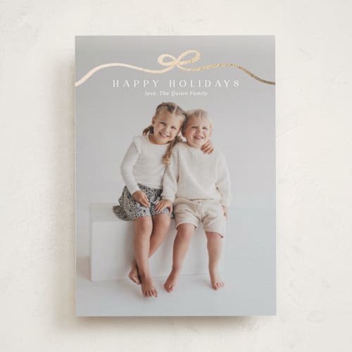 This is a snow foil pressed holiday cards with foil pressed by Kaydi Bishop called bow tied printing on recycled smooth signature in standard