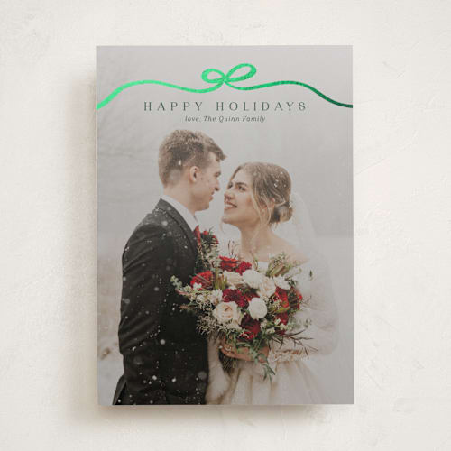 This is a pine foil pressed holiday cards with foil pressed by Kaydi Bishop called bow tied printing on recycled smooth signature in standard