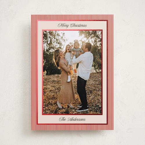 This is a ruby foil pressed holiday cards with foil pressed by Annie Shapiro called little stripes printing on recycled smooth signature in standard