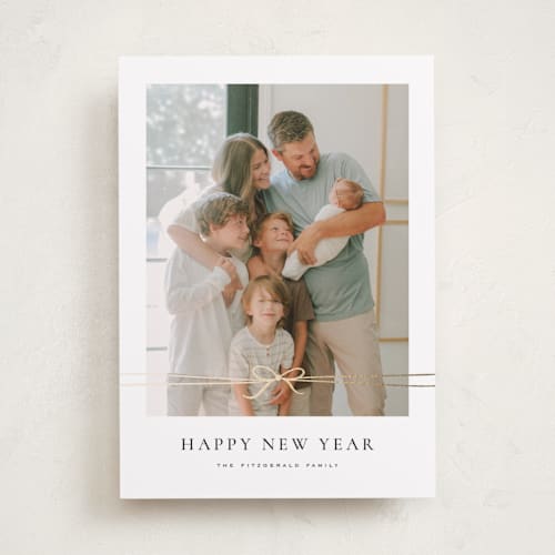 This is a coal foil pressed holiday cards with foil pressed by Wildfield Paper Co called delicate ribbon printing on recycled smooth signature in standard