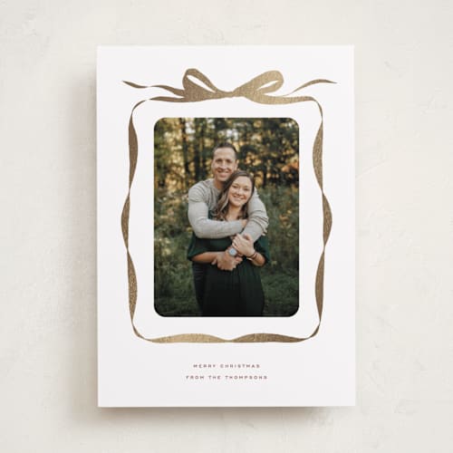 This is a nutmeg foil pressed holiday cards with foil pressed by Olivia Kanaley Inman called bow printing on recycled smooth signature in standard