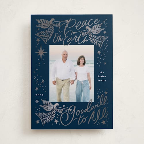 This is a navy foil pressed holiday cards with foil pressed by Alethea and Ruth called peace on earth angels printing on recycled smooth signature in standard