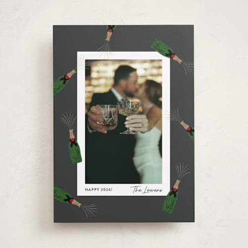 This is a charcoal new year photo cards with standard by Shari Margolin called popping bottles printing on recycled smooth signature in standard
