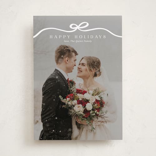 This is a snow holiday photo cards with standard by Kaydi Bishop called bow tied printing on recycled smooth signature in standard