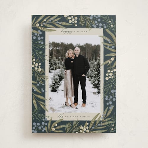 This is a juniper holiday photo cards with standard by Wildfield Paper Co called mistletoe + holly printing on recycled smooth signature in standard