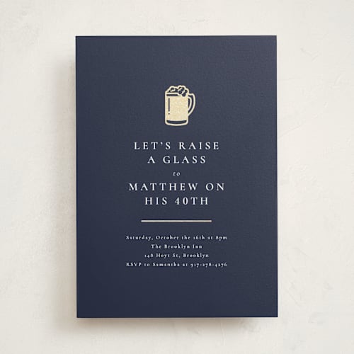 This is a navy holiday party invitations with foil pressed by mo kelley called raise a glass printing on signature in standard