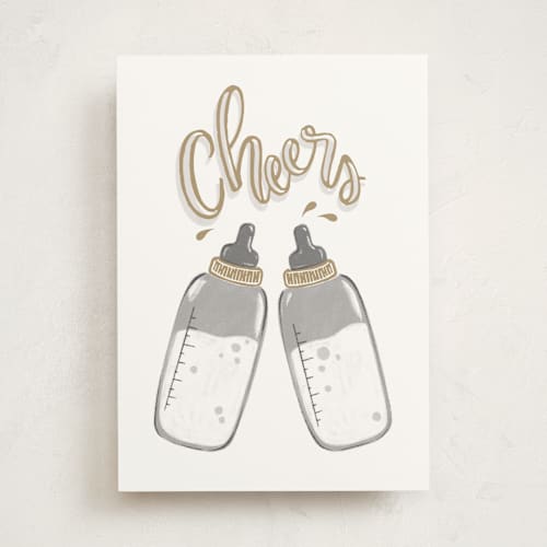 This is a gold new baby greeting cards with standard by Snow and Ivy called bottle cheers printing on signature in greeting cards