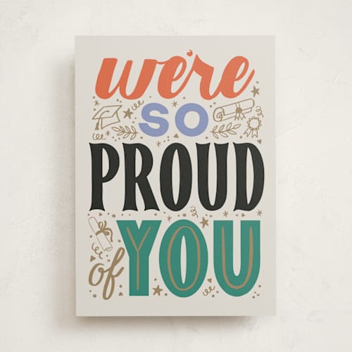 This is a ivory graduation cards with standard by Alethea and Ruth called we're so proud of you printing on signature in greeting cards