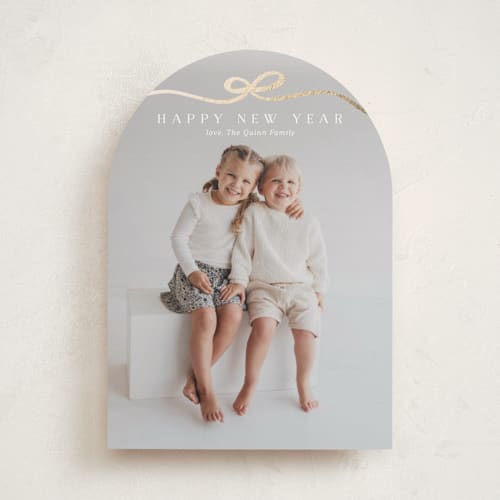 This is a snow foil pressed holiday cards with foil pressed by Kaydi Bishop called bow tied printing on recycled smooth signature in standard