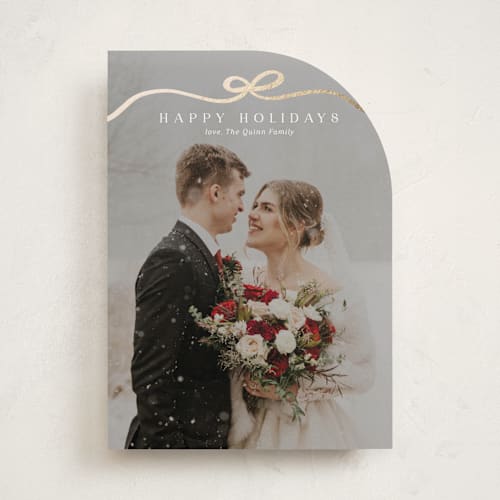 This is a snow foil pressed holiday cards with foil pressed by Kaydi Bishop called bow tied printing on recycled smooth signature in standard