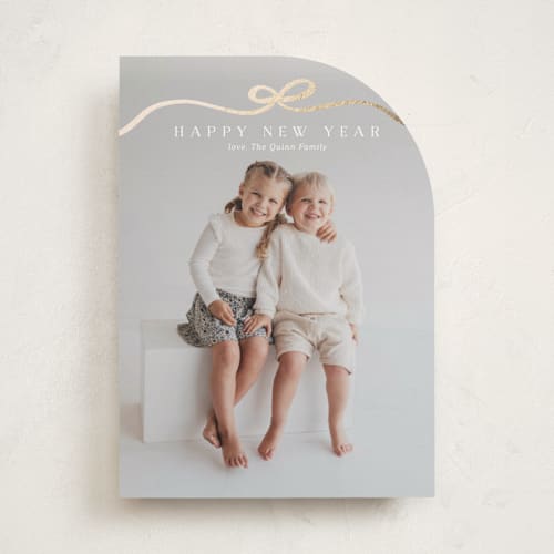 This is a snow foil pressed holiday cards with foil pressed by Kaydi Bishop called bow tied printing on recycled smooth signature in standard
