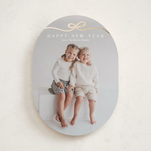 This is a snow foil pressed holiday cards with foil pressed by Kaydi Bishop called bow tied printing on recycled smooth signature in standard