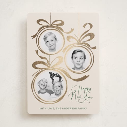 This is a champagne foil pressed holiday cards with foil pressed by Paper Sun Studio called baubles and bows printing on recycled smooth signature in standard