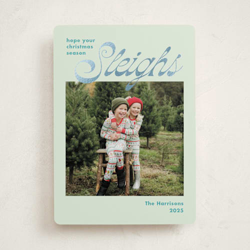 This is a turquoise foil pressed holiday cards with foil pressed by Megan Davis called sleighs printing on recycled smooth signature in standard