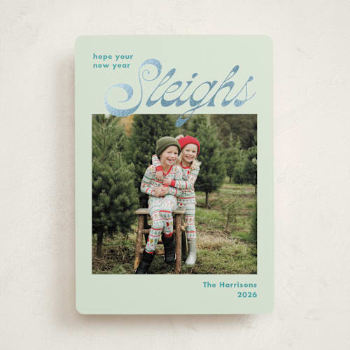 This is a turquoise foil pressed holiday cards with foil pressed by Megan Davis called sleighs printing on recycled smooth signature in standard