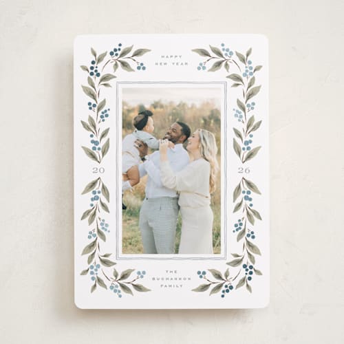 This is a juniper berry foil pressed holiday cards with foil pressed by Wildfield Paper Co called poinsettia + pine printing on recycled smooth signature in standard