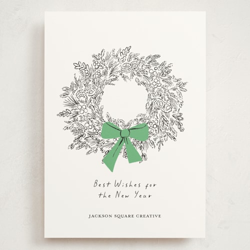 This is a greenery holiday photo cards with standard by mo kelley called wreath with bow printing on signature in grand