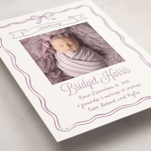 This is a lavander birth announcement postcards with standard by Cass Loh called bow frame printing on signature in postcard