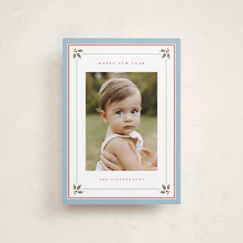 This is a powder blue petite holiday cards with standard by Wildfield Paper Co called holly berry border printing on recycled smooth signature in petite