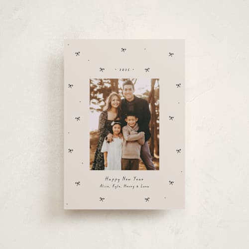 This is a vanilla petite holiday cards with standard by Lea Delaveris called little bows printing on recycled smooth signature in petite