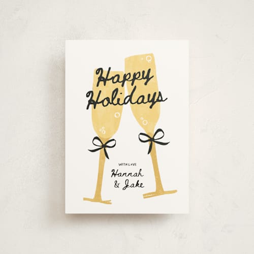 This is a champagne christmas postcards with standard by Kamala Nahas called cheers printing on signature in postcard