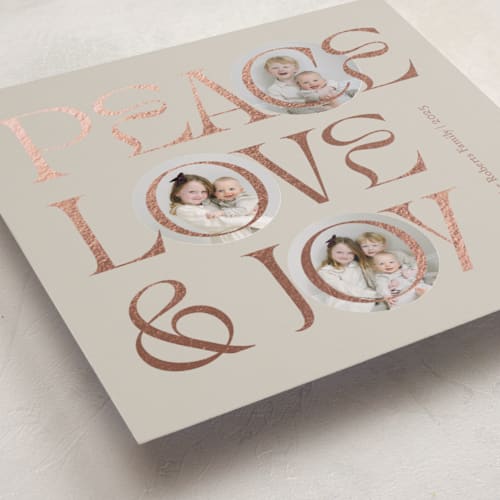 This is a toffee foil pressed holiday cards with foil pressed by Carolyn Kach called peace love & joy printing on recycled smooth signature in standard