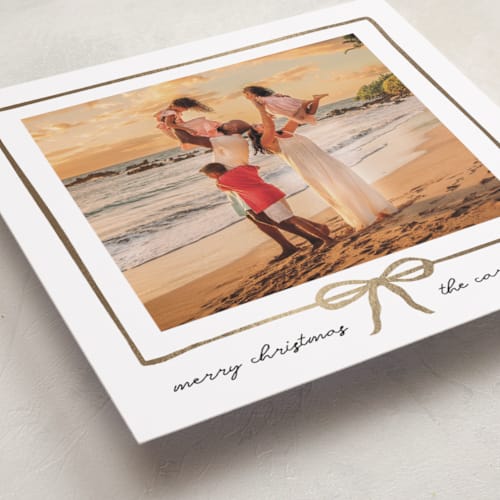 This is a snowfall foil pressed holiday cards with foil pressed by Jennifer Lew called lil bow printing on recycled smooth signature in standard