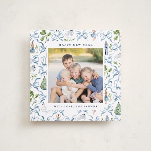 This is a blue ribbon holiday photo cards with standard by Sarah Knight called nutcracker ribbons printing on recycled smooth signature in square