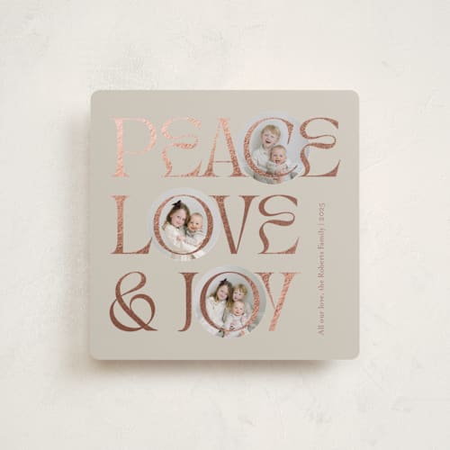 This is a toffee foil pressed holiday cards with foil pressed by Carolyn Kach called peace love & joy printing on recycled smooth signature in standard