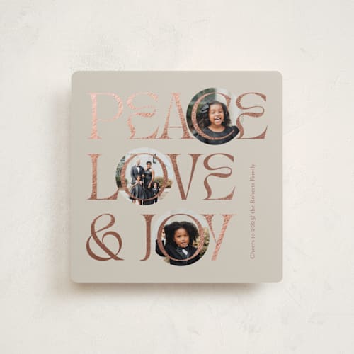 This is a toffee foil pressed holiday cards with foil pressed by Carolyn Kach called peace love & joy printing on recycled smooth signature in standard