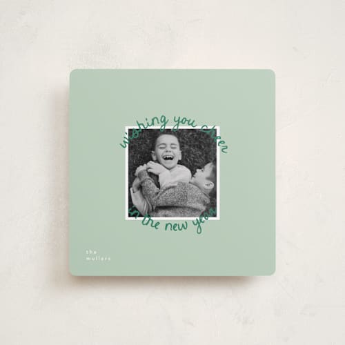 This is a mistletoe holiday photo cards with standard by Christie Garcia called circale printing on recycled smooth signature in square