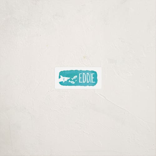 This is a turquoise name labels with standard by Ava Thomson called shark chase printing on waterproof sticker paper in sticker