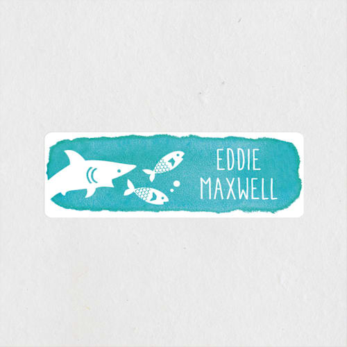 This is a turquoise name labels with standard by Ava Thomson called shark chase printing on waterproof sticker paper in sticker